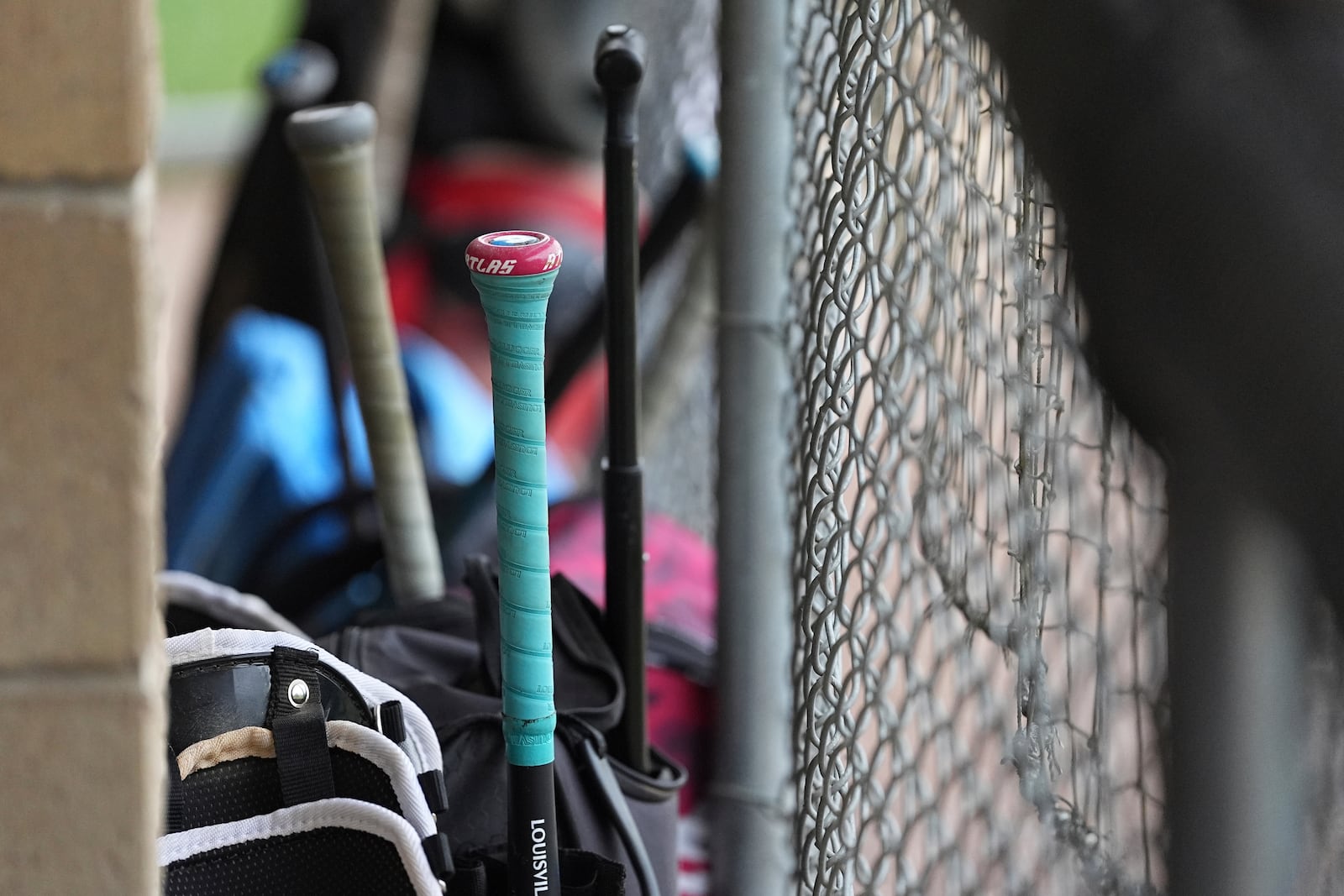 Sports equipment lines the dugout ahead of a youth baseball game in Aston, Pa., Tuesday, May 27, 2025. (AP Photo/Matt Rourke)