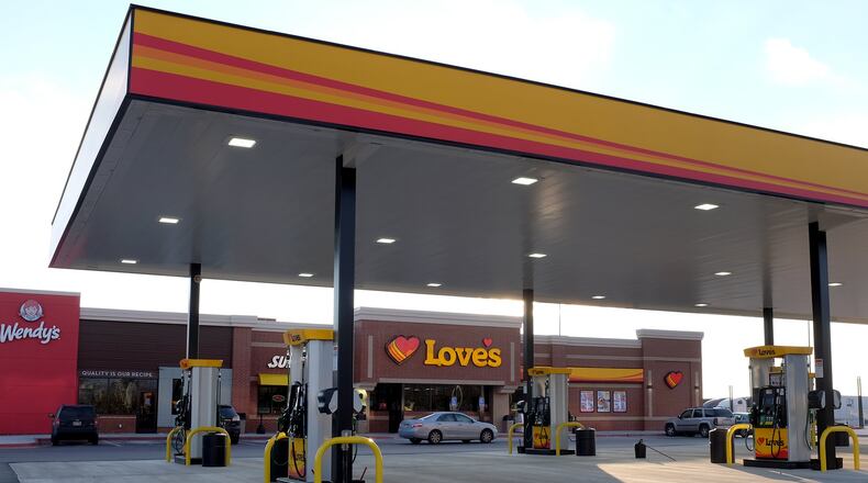The Love’s Travel Stop at the intersection of I-70 and Route 41 held its ribbon-cutting on Tuesday, donating $2,000 to the United Way of Clark, Champaign and Madison Counties. BILL LACKEY/STAFF