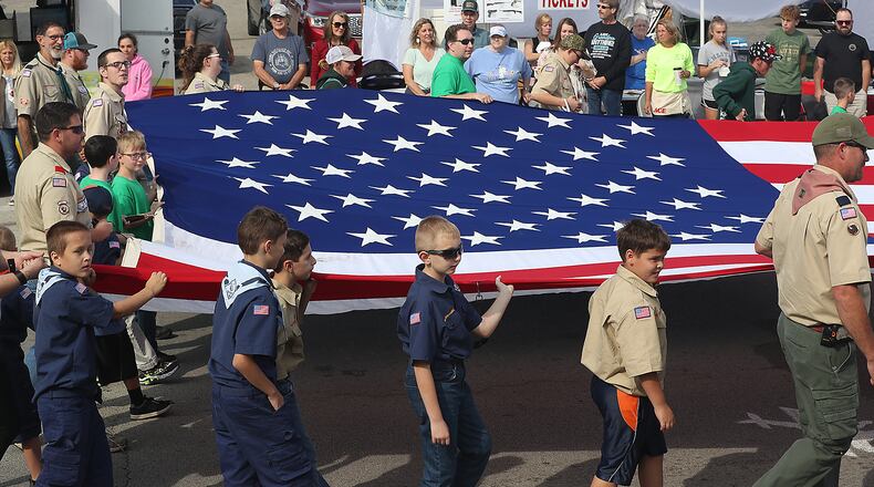 The New Carlisle Heritage of Flight Festival last year with the Airplane Parade down Main Street. Hundreds of people lined the street to see the floats as well as the airplanes towed by vintage tractors. BILL LACKEY/STAFF