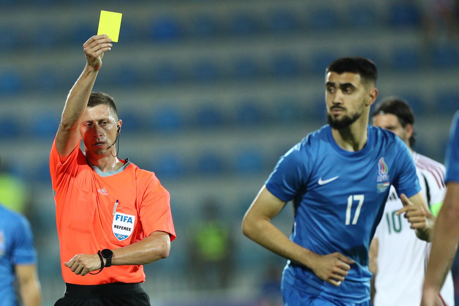 Referee Viktor Shimusik shows a yellow card to Azerbaijan's Tural Bayramov during an international friendly soccer match at Dalga Arena in Baku, Azerbaijan, Tuesday, June 10, 2025. (AP Photo)