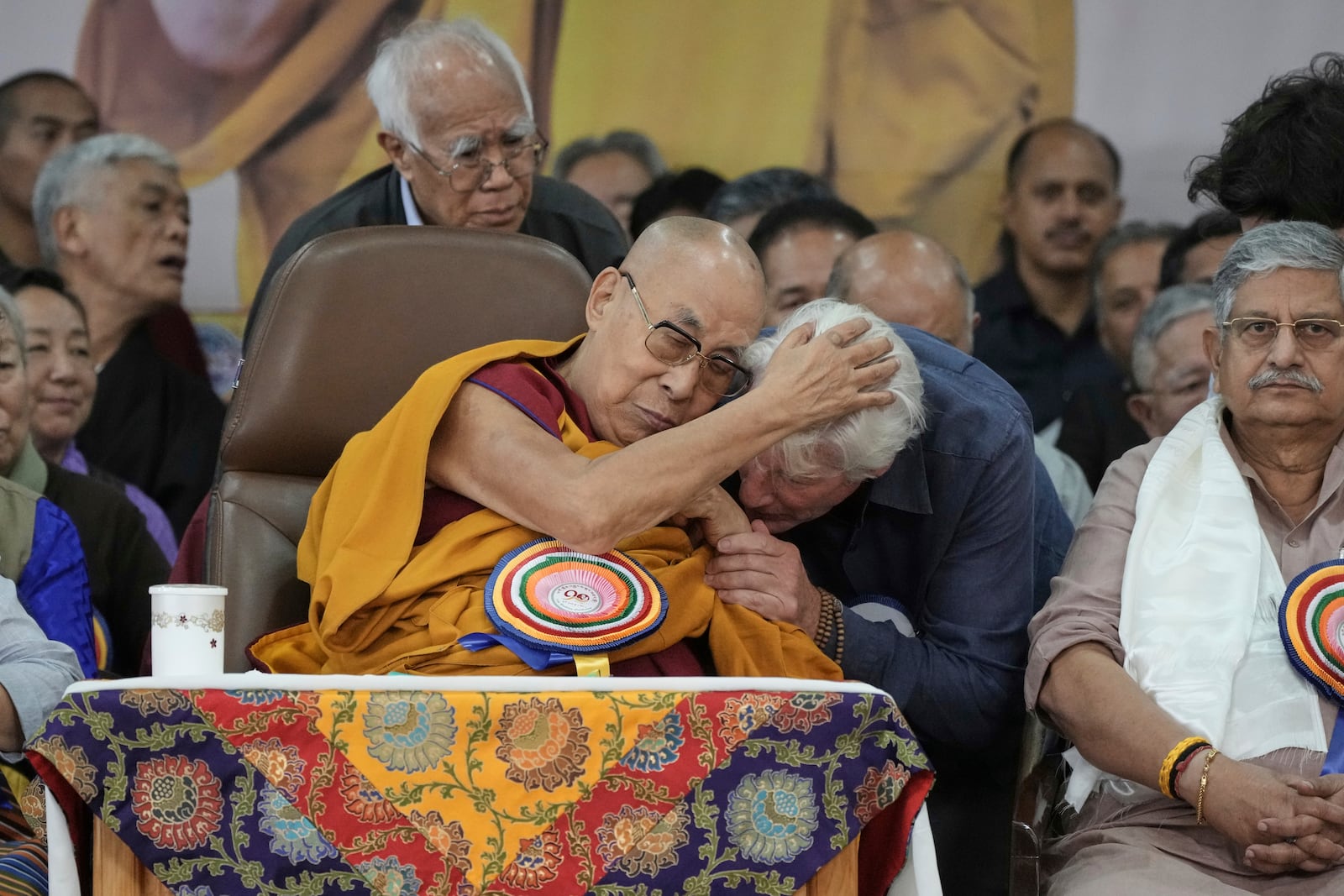 Actor Richard Gere, center right, wishes Tibetan spiritual leader the Dalai Lama at an event celebrating the Dalai Lama's 90th birthday in Dharamshala, India, Sunday, July 6, 2025. (AP Photo/Ashwini Bhatia)