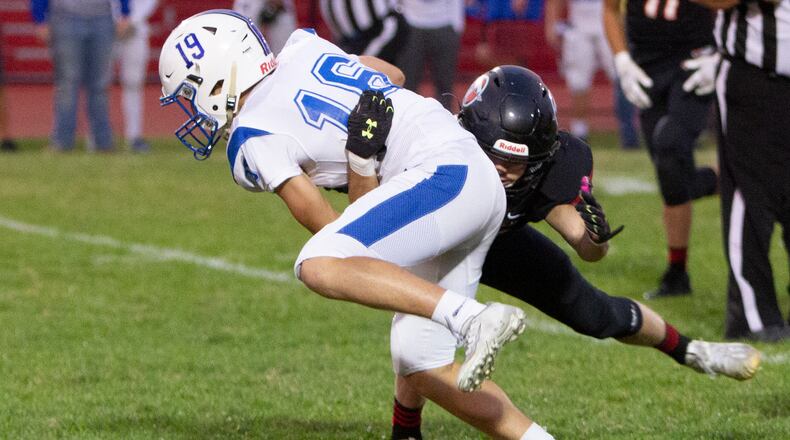Xenia's Blake Owens is tackled after making a reception in the first half of Xenia's 18-0 Division II playoff victory Friday at Tecumseh. Jeff Gilbert/CONTRIBUTED
