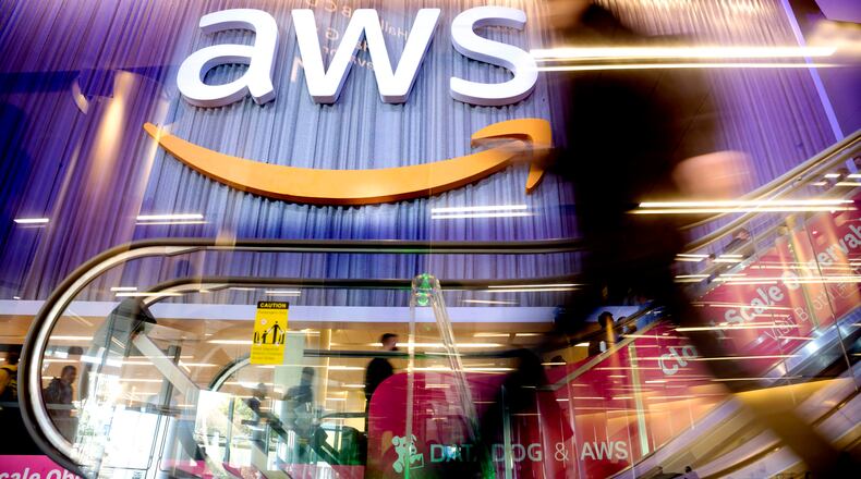 An attendee walks through AWS re:Invent 2022, a conference hosted by Amazon Web Services, on Wednesday, Nov. 30, 2022, in Las Vegas.  Ohio Governor Mike DeWine and Lt. Governor Jon Husted announced Monday, June 26, 2023, that Amazon Web Services (AWS) will invest an estimated $7.8 billion by the end of 2029 to expand its data center operations in Central Ohio, creating hundreds of new jobs. (Noah Berger/Amazon Web Services via AP Images)