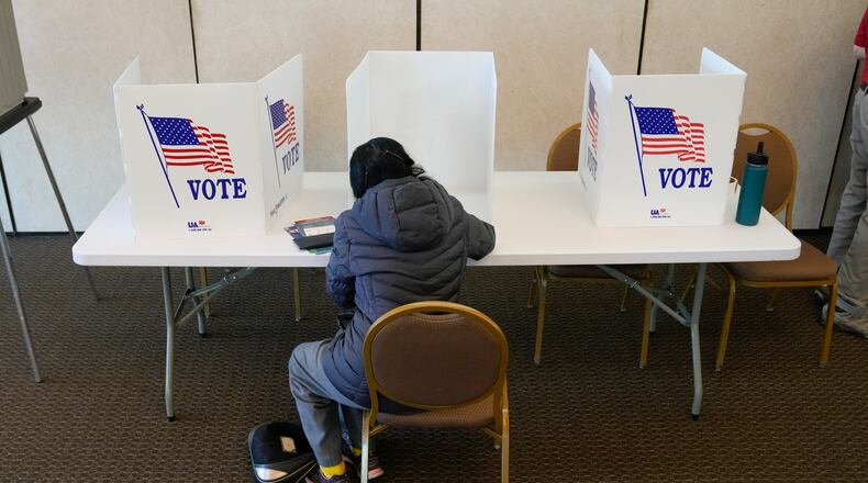 An Ohio voter fills out a manual ballot as voting continued at the Meadowbook Golf Club in Clayton, Ohio Tuesday, Nov. 8, 2022. (AP Photo/Michael Conroy)