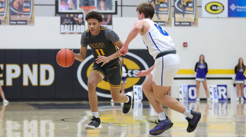 Cutline: Springfield High School junior Eddie Muhammad drives past Springboro’s Ben Marcum during their game on Friday night at Centerville High School. The Wildcats won 87-57. Michael Cooper/CONTRIBUTED