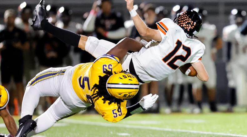 Springfield High School senior defensive lineman Royce Rogers tackles Beavercreek senior quarterback Jack Minnick during their game on Friday, Oct. 10 at Wildcat Stadium. Springfield won 31-0. MICHAEL COOPER / STAFF PHOTO