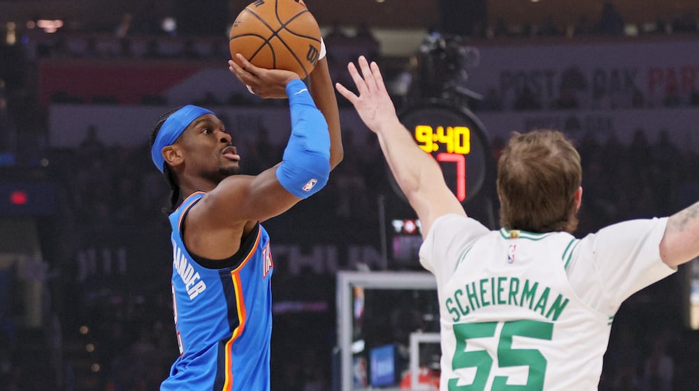 Oklahoma City Thunder guard Shai Gilgeous-Alexander, left, looks to shoot against Boston Celtics guard Baylor Scheierman (55) during the first half of an NBA basketball game, Thursday, March 12, 2026, in Oklahoma City. (AP Photo/Nate Billings)