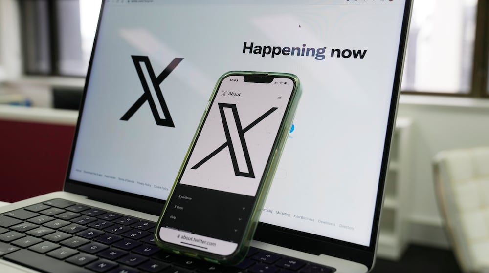 FILE - The opening page of X is displayed on a computer and phone, Oct. 16, 2023, in Sydney. (AP Photo/Rick Rycroft, File)