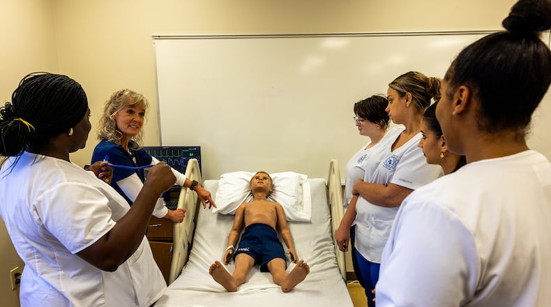 Katherine Stute, RN, Clark State’s coordinator of nursing skills and simulation labs, works with students at Clark State’s Beavercreek campus on high fidelity mannequins that breath, cry, and blink to help students obtain realistic experience. Clark State can begin offering bachelor’s degrees in nursing once approved by the Higher Learning Commission and receiving final approval from the state. Contributed