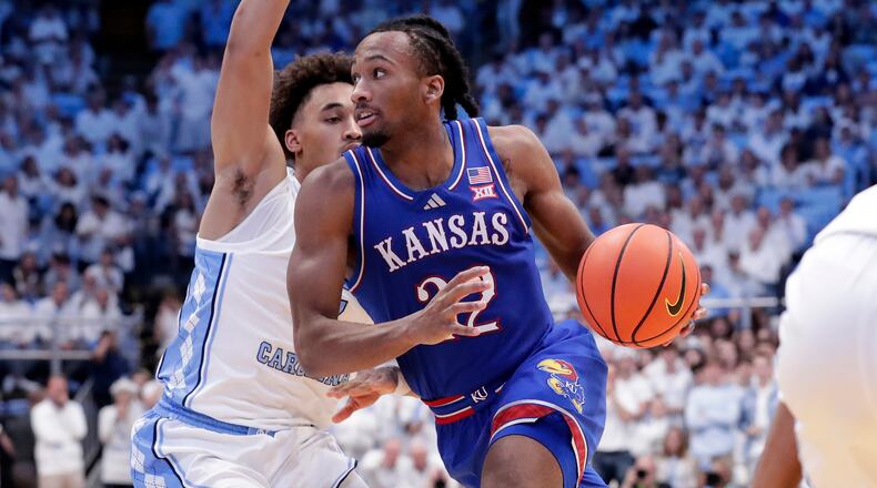 Kansas guard Darryn Peterson, right, drives against North Carolina guard Seth Trimble, left, during the second half of an NCAA college basketball game Friday, Nov. 7, 2025, in Chapel Hill, N.C. (AP Photo/Chris Seward)
