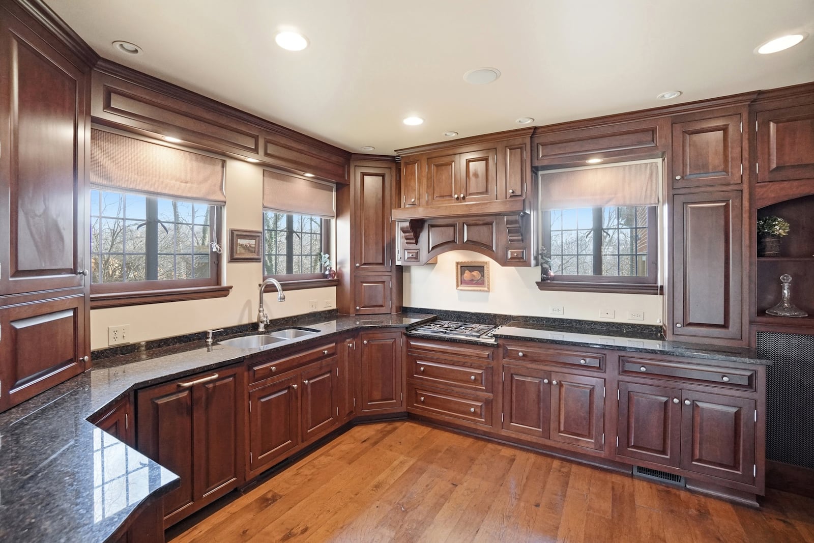 the updated kitchen features custom wood cabinets, appliances including a gas cooktop, hardwood floors, recessed lighting and a breakfast nook. CONTRIBUTED