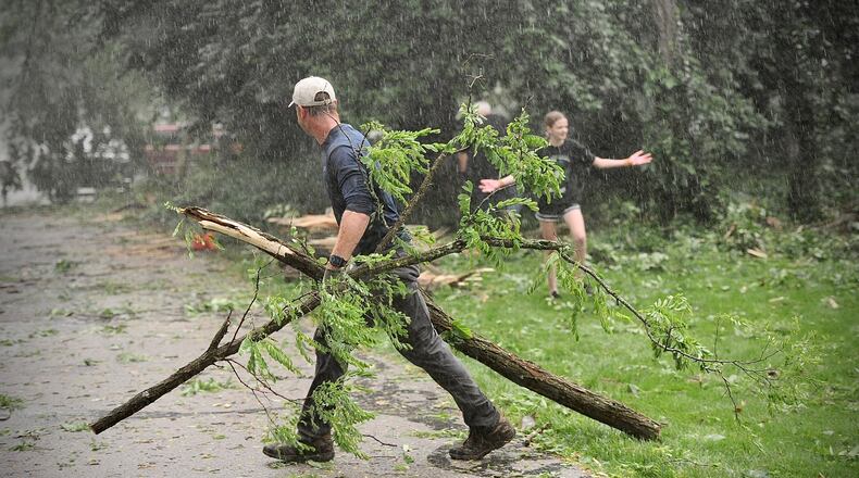 Storms in Clark County Wednesday, June 8, 2022, knocked down several trees and damaged property, including homes and cars, on Lisa Court in Springfield. Neighbors came out after it was safe to help each other. MARSHALL GORBY/STAFF
