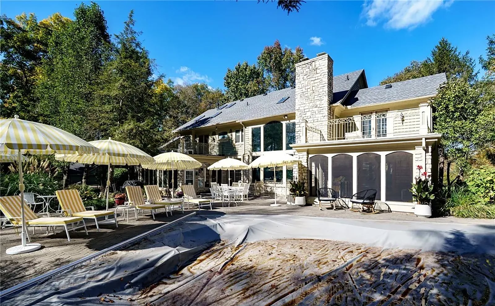 the back paver patio has extensive seating areas and an inground pool with a slide. The lot is wooded at the rear and sides. CONTRIBUTED