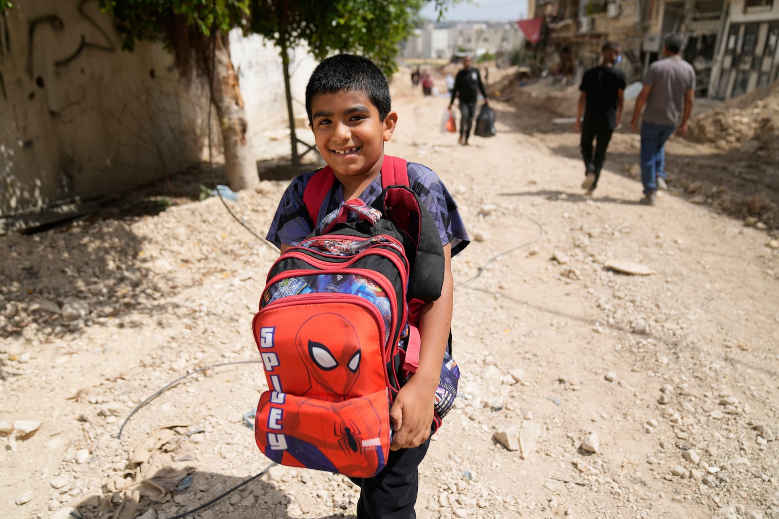 Residents of the now evacuated refugee camp of Tulkarem return to collect belongings before the destruction of their homes as Israeli forces prepare to carry out the demolition of 116 homes across the two refugee camps of the Israeli occupied West Bank city of Tulkarem, Friday, May 2, 2025. (AP Photo/Nasser Nasser)