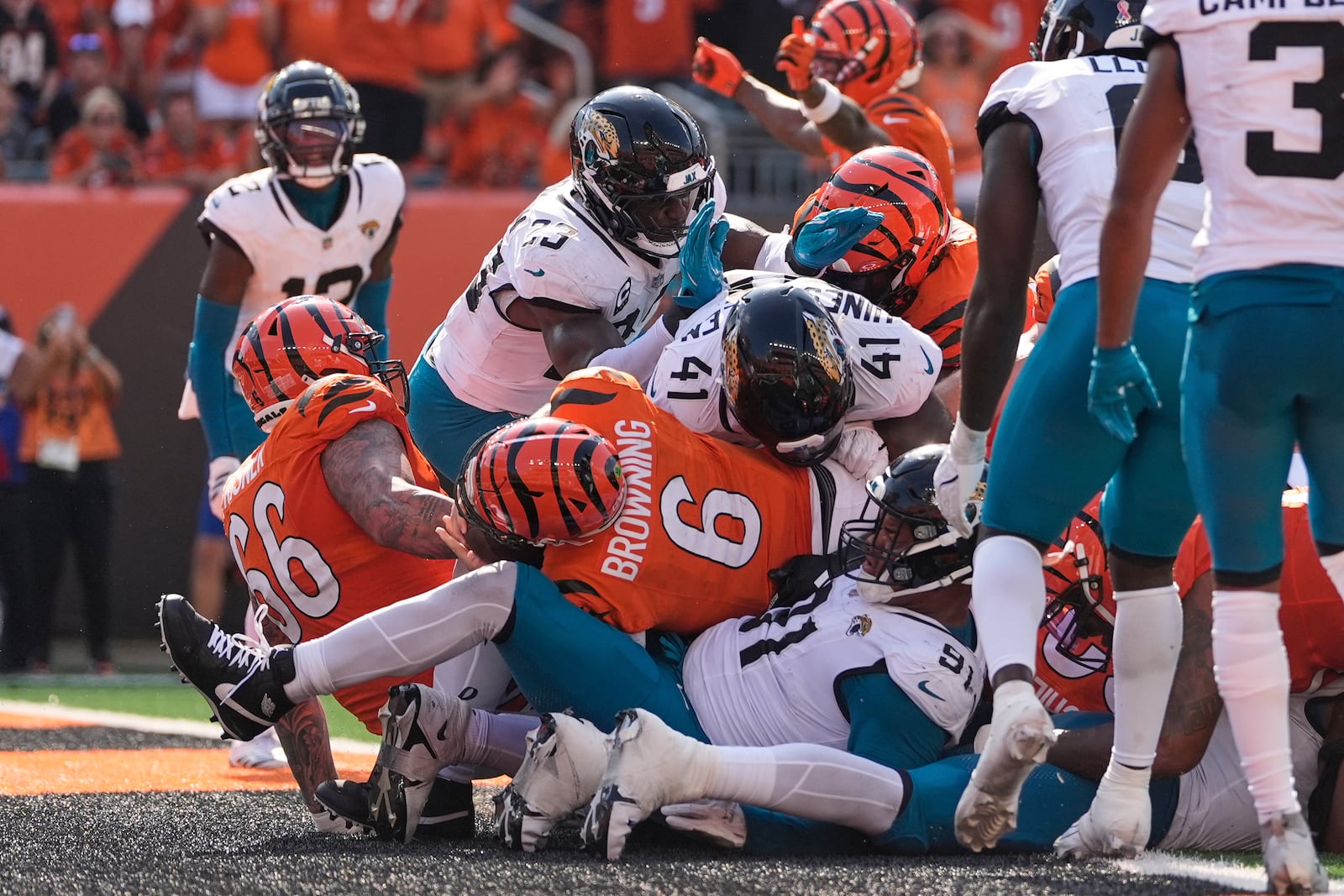 Cincinnati Bengals quarterback Jake Browning (6) lunges into the end zone to score a touchdown during the second half of an NFL football game against the Jacksonville Jaguars, Sunday, Sept. 14, 2025, in Cincinnati. (AP Photo/Carolyn Kaster)