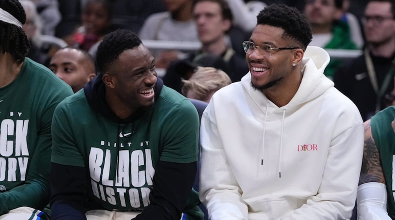 Milwaukee Bucks' Giannis Antetokounmpo smiles on the bench with Thanasis Antetokounmpo during the first half of an NBA basketball game Wednesday, Feb. 4, 2026, in Milwaukee. (AP Photo/Morry Gash)
