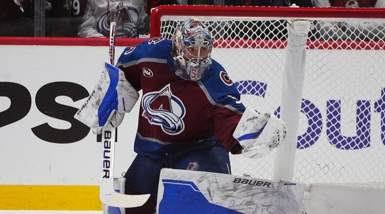 Colorado Avalanche goaltender Trent Miner makes a glove save in the first period of an NHL hockey game against the Columbus Blue Jackets Saturday, Jan. 10, 2026, in Denver. (AP Photo/David Zalubowski)