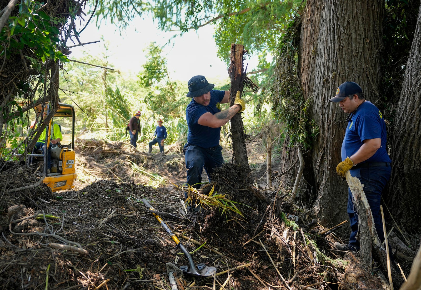 La Salle County Fire Rescue firefighters do search and rescue work on the banks of the Guadalupe River in Ingram, Texas, Tuesday, July 8, 2025, after the Fourth of July flood. (Jay Janner/Austin American-Statesman via AP)