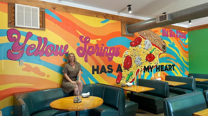 Dayton-area artist Chloé Chicarelli has put her love for Yellow Springs and Ha Ha Pizza on display through a new mural inside the pizza shop. NATALIE JONES/STAFF