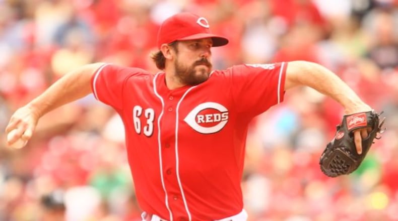 Sam LeCure pitches for the Reds in the seventh. The Reds beat the A's 6-5 on Wednesday, Aug. 7, 2013, at Great American Ball Park in Cincinnati.