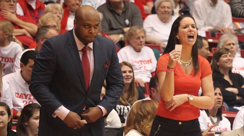 Dayton's Shauna Green, right, and Simon Harris watch a game against Saint Louis on Feb. 22, 2017, at UD Arena. David Jablonski/Staff
