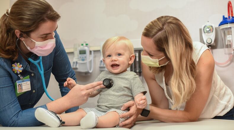 FILE - A doctor exams a patient at Dayton Children's Hospital. Dayton Children's has been seeing a gradual increase in COVID cases, but is expecting a winter wave of respiratory illnesses. Dayton Children's recommends infants get vaccinated against RSV this fall in order to prevent serious illness from RSV. COURTESY OF DAYTON CHILDREN'S HOSPITAL