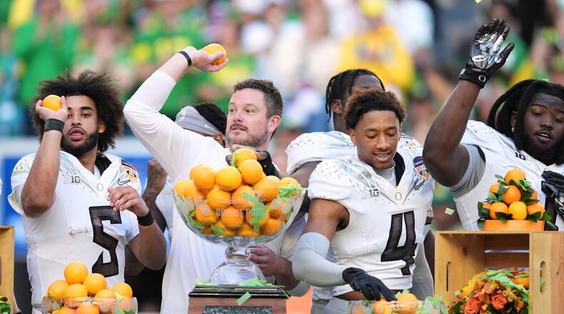 Oregon head coach Dan Lanning, second left, celebrates with quarterback Dante Moore (5), defensive back Brandon Finney Jr. (4), and defensive lineman Bear Alexander after defeating Texas Tech in the Orange Bowl College Football Playoff quarterfinal game, Thursday, Jan. 1, 2026, in Miami Gardens, Fla. (AP Photo/Rebecca Blackwell)