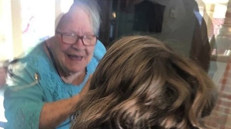 Graham Golden visits his grandma, Marge Golden, outside the window at Hearth & Home at Harding in Springfield due to restrictions because of the coronavirus threat.
