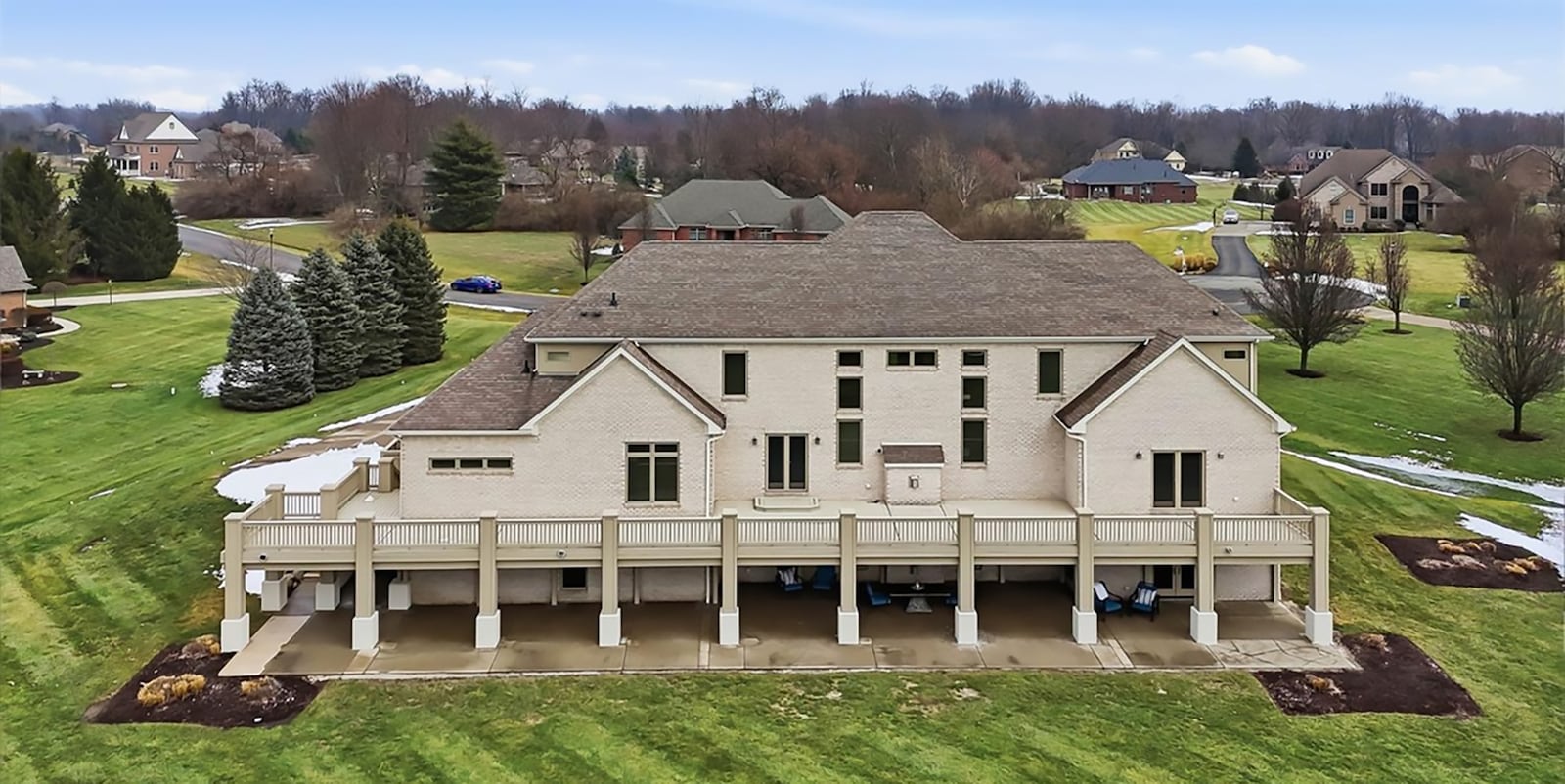 The back of the home has an upper level deck that wraps around to the side and a basement level patio that also wraps around the side. Both the concrete patio and the deck extend across the entire back of the home. CONTRIBUTED