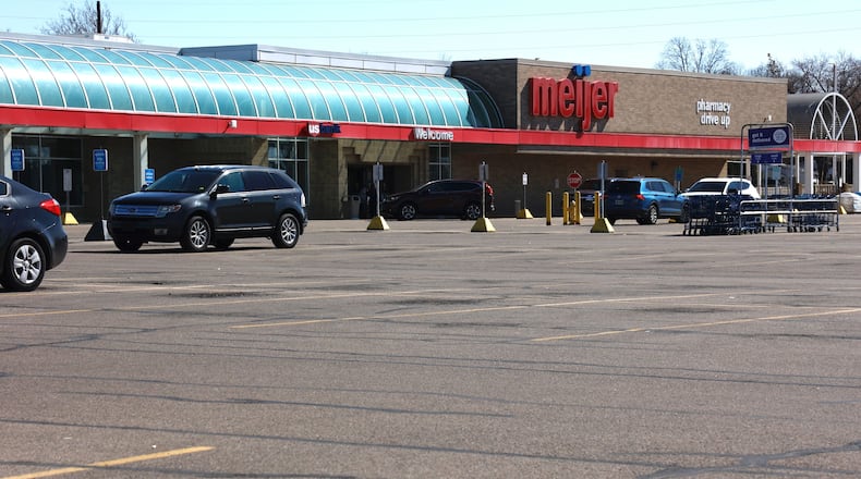 The parking lot of Springfield Meijer store is almost empty Tuesday, March 7, 2023 after a morning generator fire on the roof of the business left them without power and forcing them to close. BILL LACKEY/STAFF