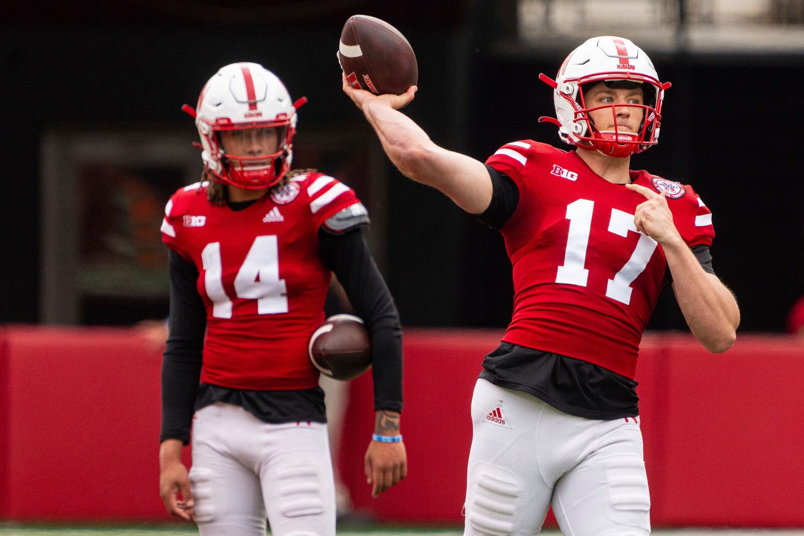 Nebraska quarterback Luke Longval (17) and quarterback TJ Lateef (14) work on passes during an NCAA college football practice Saturday, April 26, 2025, in Lincoln, Neb. (AP Photo/Dylan Widger)