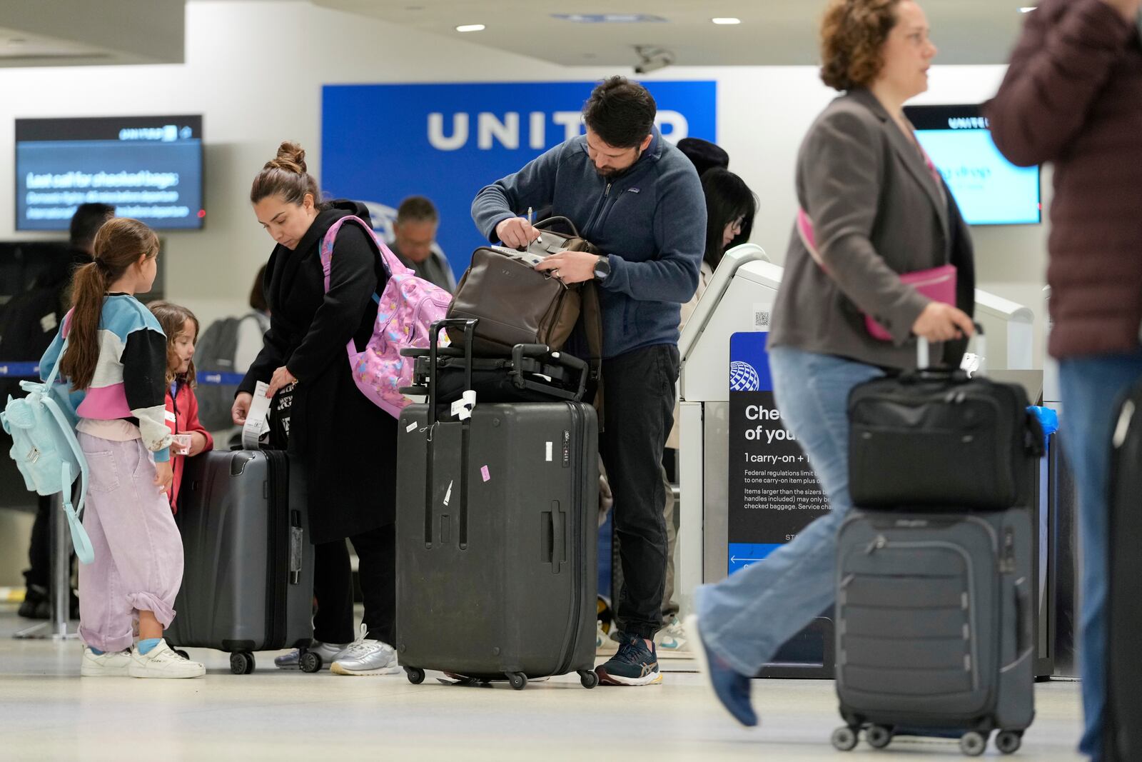 Travelers check into their flights at Newark Liberty International Airport in Newark, N.J., Monday, May 5, 2025. (AP Photo/Seth Wenig)