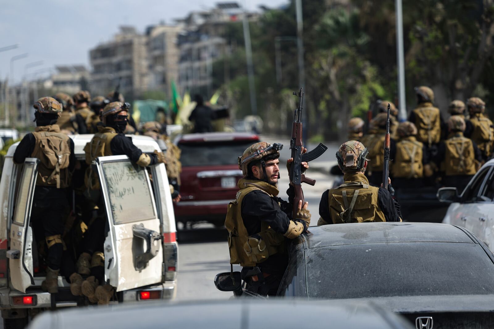 U.S.-backed Kurdish fighters withdraw from two neighbourhoods in Syria's northern city of Aleppo as part of a deal with the Syrian central government, in Aleppo, Syria, Friday, April 4, 2025. (AP Photo/Ghaith Alsayed)