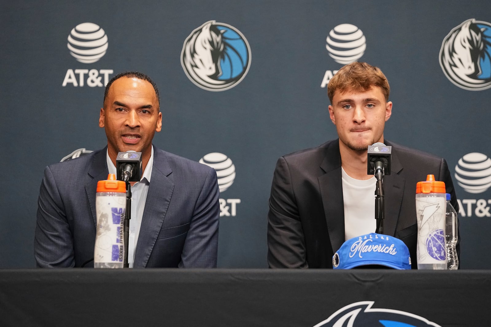 Dallas Mavericks President of Basketball Operations and General Manager Nico Harrison, left, responds to a question as the Mavericks' Cooper Flagg, right, the No. 1 overall pick in the NBA draft, looks on during an NBA basketball press conference at the team's practice facility, Friday, June 27, 2025, in Dallas. (AP Photo/Tony Gutierrez)