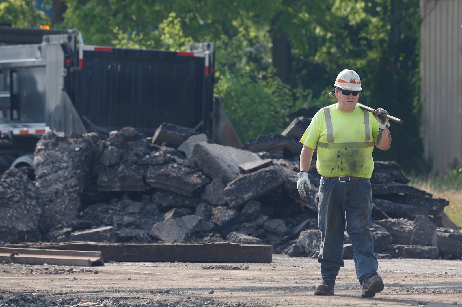 A construction worker handles paving work on West Main Street on Wednesday, June 4, 2025, in Springfield. JOSEPH COOKE/STAFF