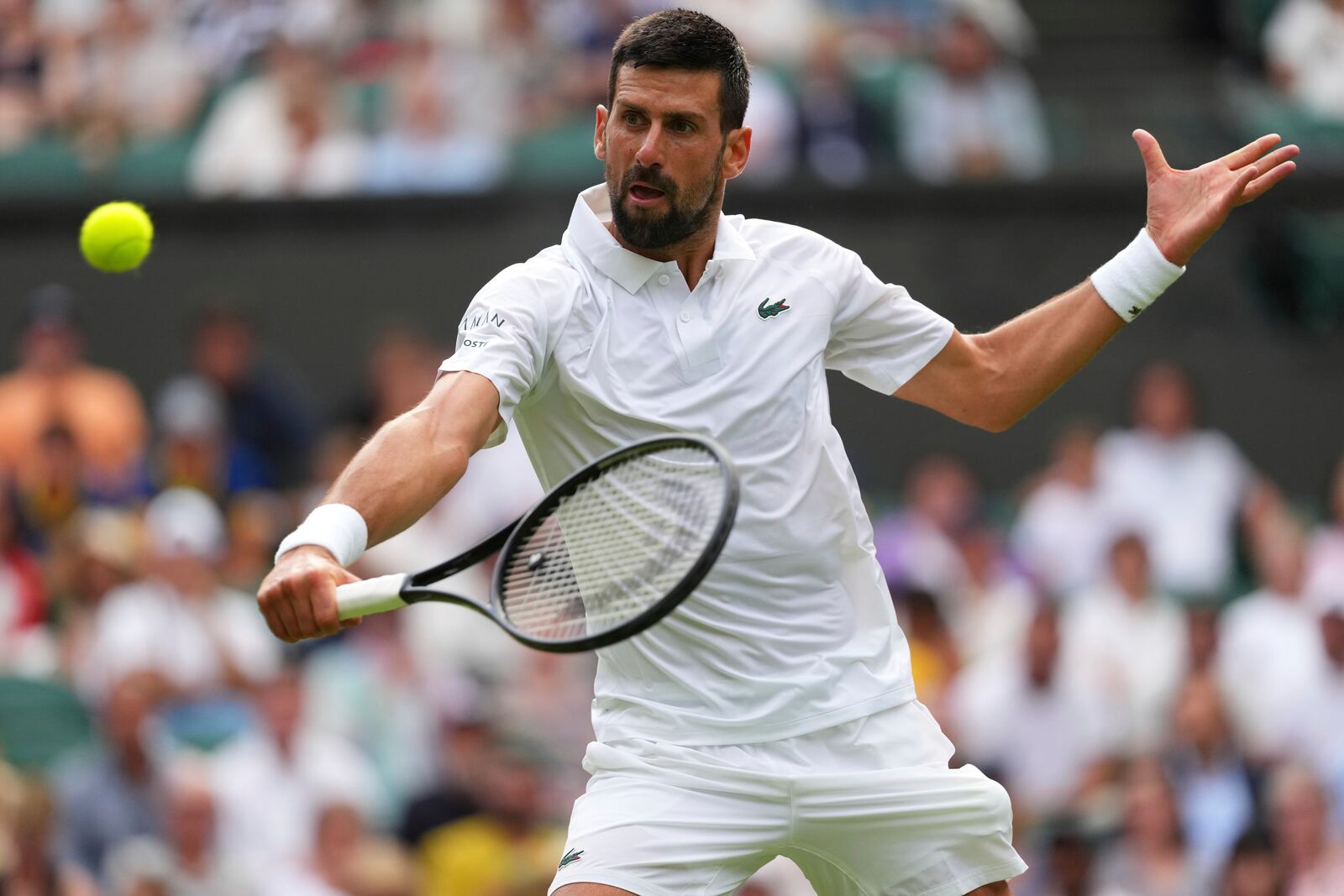 Novak Djokovic of Serbia returns to Miomir Kecmanovic of Serbia during a third round men's singles match at the Wimbledon Tennis Championships in London, Saturday, July 5, 2025. (AP Photo/Kirsty Wigglesworth)