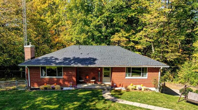 The 3-bedroom, brick ranch offers about 1,360 sq. ft. of living space with a partially finished, walk-out basement. The home is set on almost 6 acres that are wooded and has a creek. CONTRIBUTED PHOTO