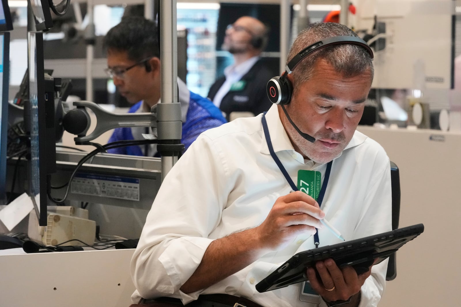 Options trader Justin Kanda, right, works on the floor of the New York Stock Exchange, Tuesday, July 8, 2025. (AP Photo/Richard Drew)