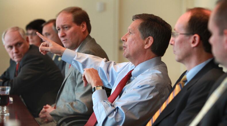 Ohio governor John Kasich, surrounded by cabinet members and staffers, makes a point in talking with The Plain Dealer editorial board at The Plain Dealer on Wed. March 16, 2011. Others at the table from rear to right front: Bonnie Kantor-Burman (Aging); Gary Mohr (Rehabilitation and Corrections); Wayne Stuble (Gov’s office, leaning forward on table); Tim Keen (OBM); Kasich; Greg Moody (Health Transformations); John McCarthy (Medicaid). (Thomas Ondrey/The Plain Dealer)