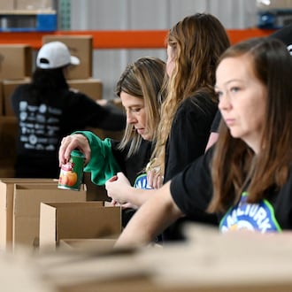 Shared Harvest saw about 60 volunteers from multiple organizations pack boxes on Friday, Nov. 14, 2025, for the annual Hamil-Turkey event where around thousands of people will be fed through these prepackaged Thanksgiving dinners. Hundreds of more people are expected to be fed at a Thanksgiving buffet dinner sponsored by various organizations. MICHAEL D. PITMAN/STAFF