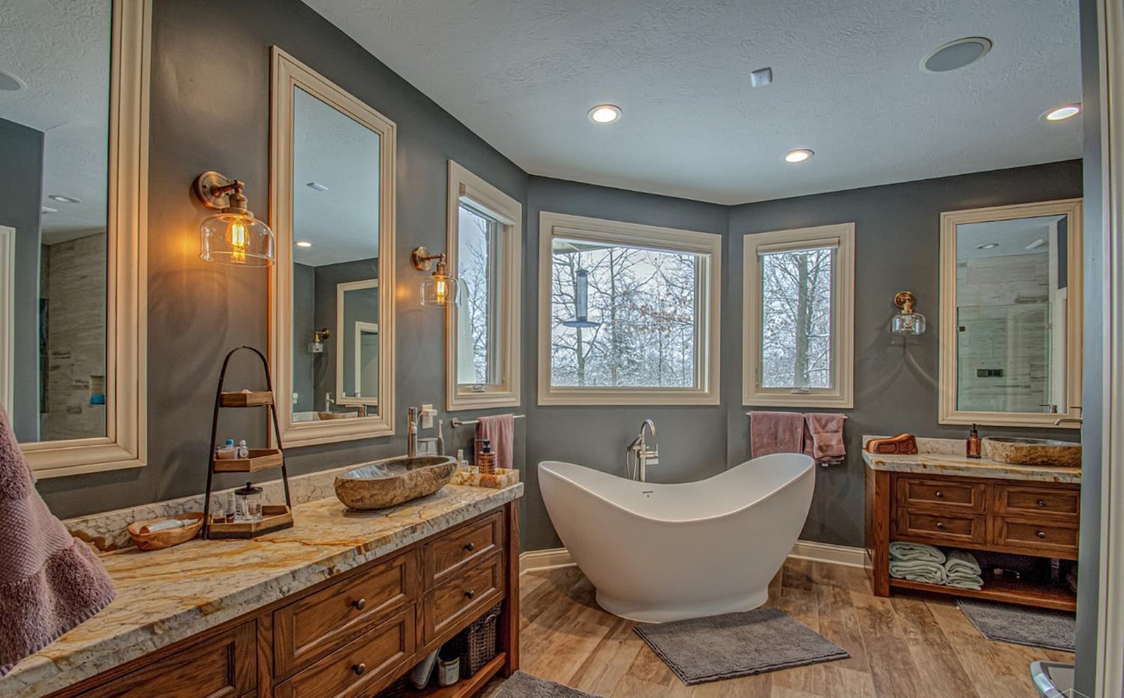 The primary bedroom ensuite bathroom has hardwood floors, two vanities, a free standing bathtub and a walk in shower. CONTRIBUTED