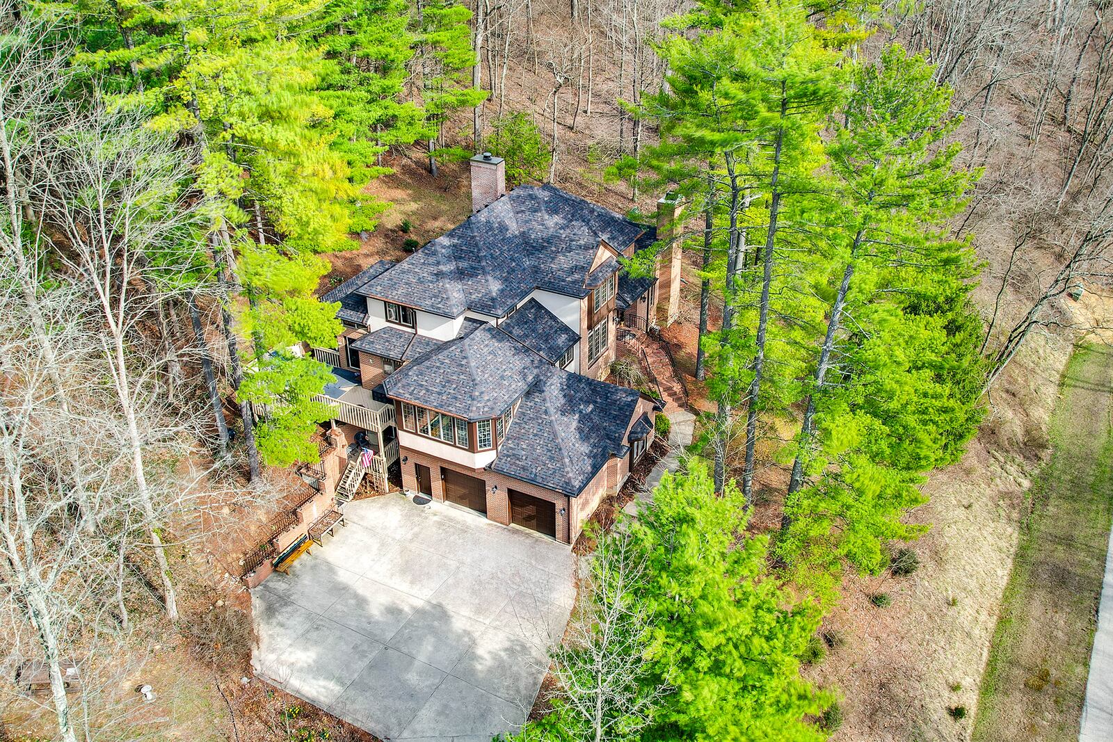 The home is surrounded by mature trees and wooded acreage.