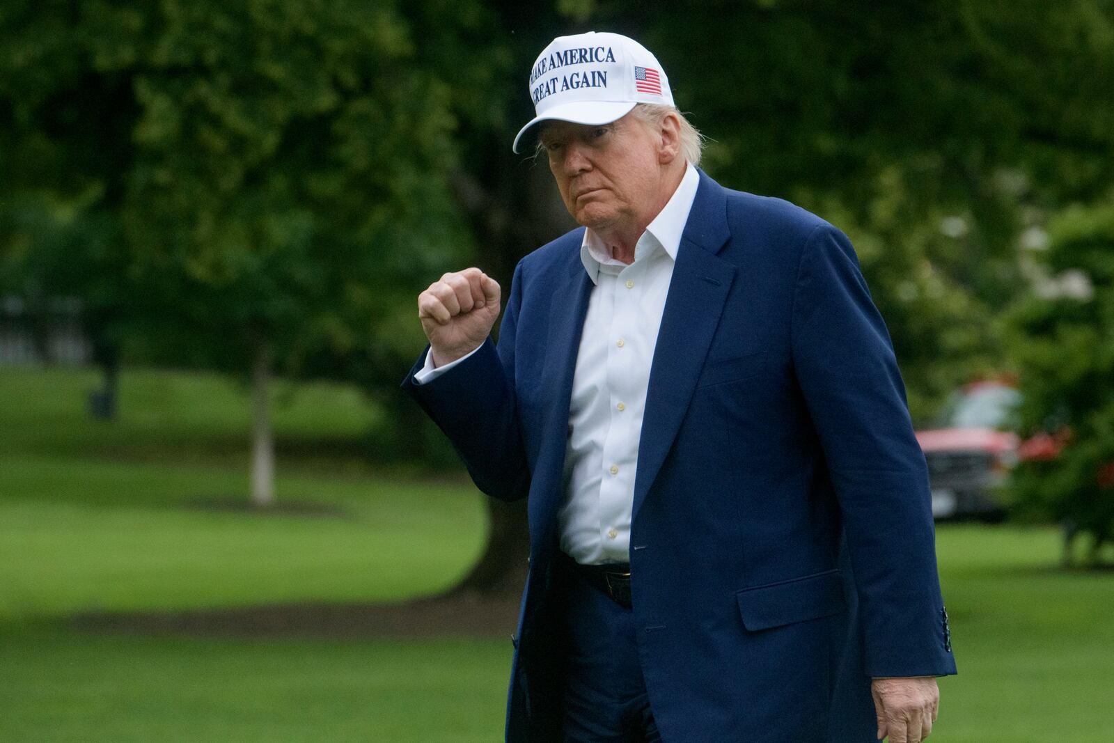President Donald Trump acknowledges reporters as he disembarks Marine One upon arrival on the South Lawn of the White House in Washington, Sunday, May 25, 2025. (AP Photo/Rod Lamkey, Jr.)