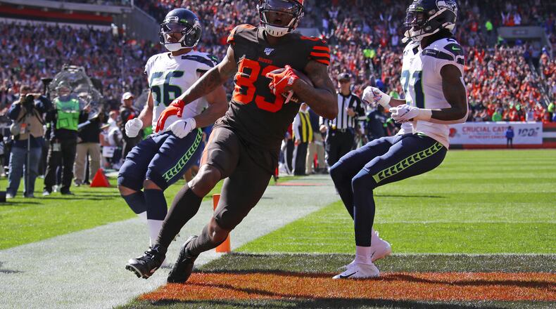 CLEVELAND, OHIO - OCTOBER 13: Ricky Seals-Jones #83 of the Cleveland Browns scores a second quarter touchdown next to Tre Flowers #21 of the Seattle Seahawks at FirstEnergy Stadium on October 13, 2019 in Cleveland, Ohio. (Photo by Gregory Shamus/Getty Images)