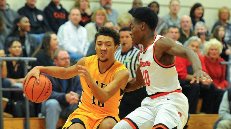 Springfield’s Danny Davis dribbles with pressure from Beavercreek’s Ian Whitlow during a GWOC National East boys basketball game on Friday night at Ed Zink Fieldhouse. BRYANT BILLING / CONTRIBUTED