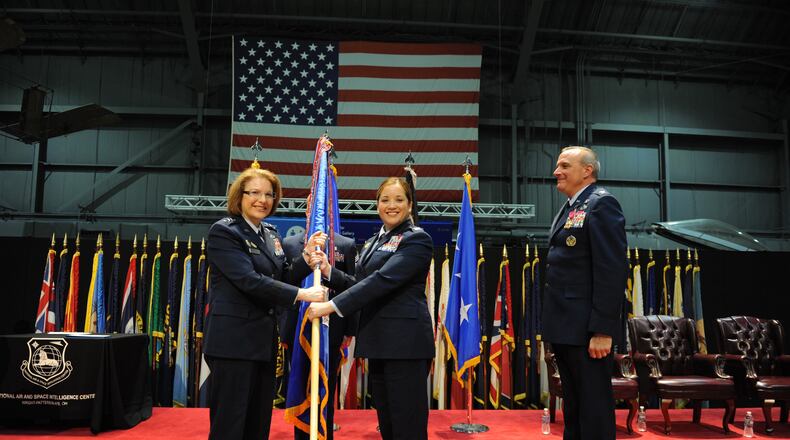 Col. Ariel G. Batungbacal (center) takes command of the National Air and Space Intelligence Center after receiving the guidon from Lt. Gen. Mary F. O’Brien, Deputy Chief of Staff for Intelligence, Surveillance, Reconnaissance and Cyber Effects Operations (left) in June 2022. U.S. Air Force photo / Senior Airman Kristof J. Rixmann