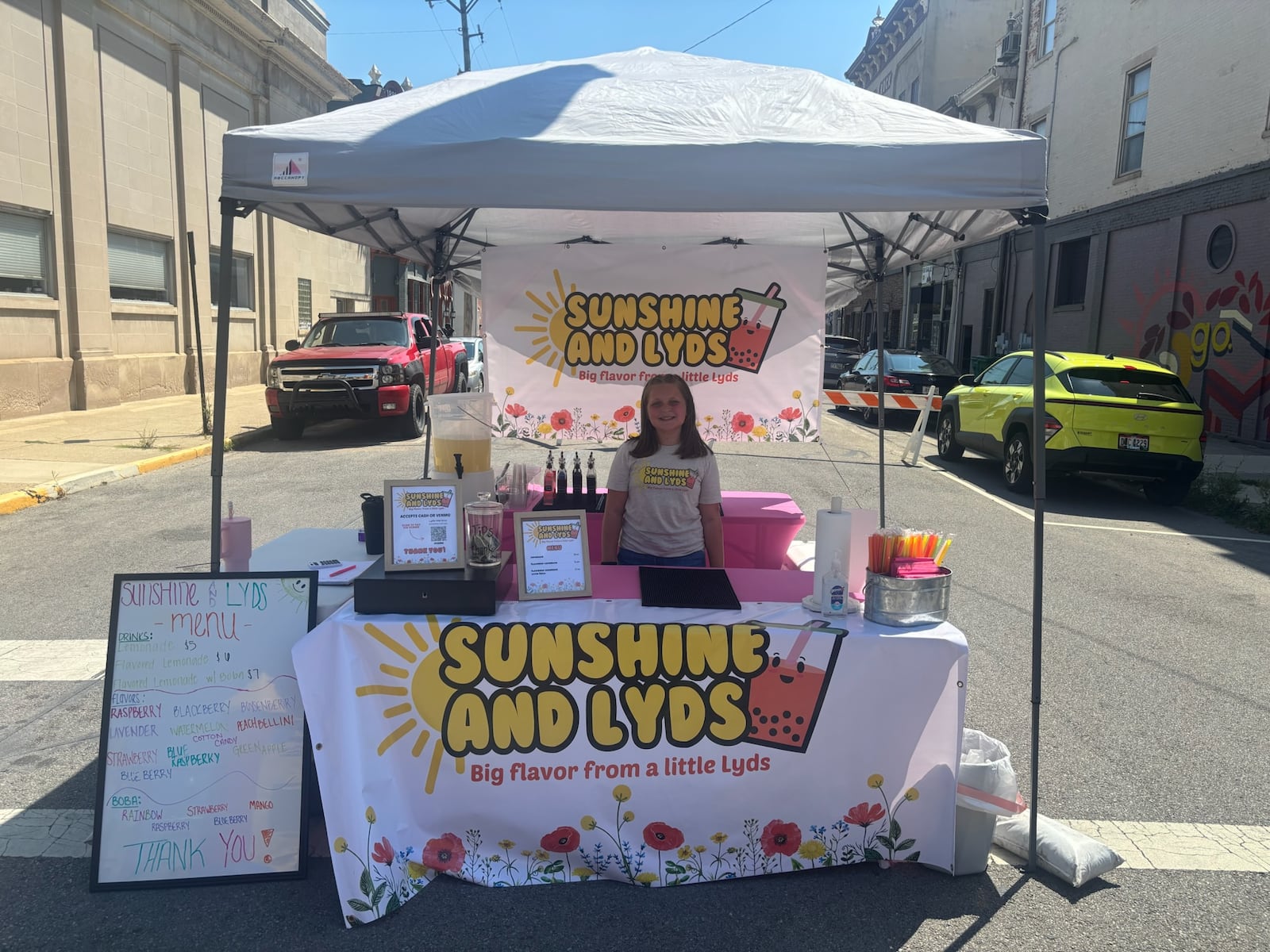 Urbana fourth grader Lydia Martinez at her Sunshine and Lyds drink stand, which started out as a pop-up stand, but is now in a converted 4-H trailer. Lydia, 9, opened the lemonade stand earlier this summer, making creative drink mixes to sell at various events. CONTRIBUTED
