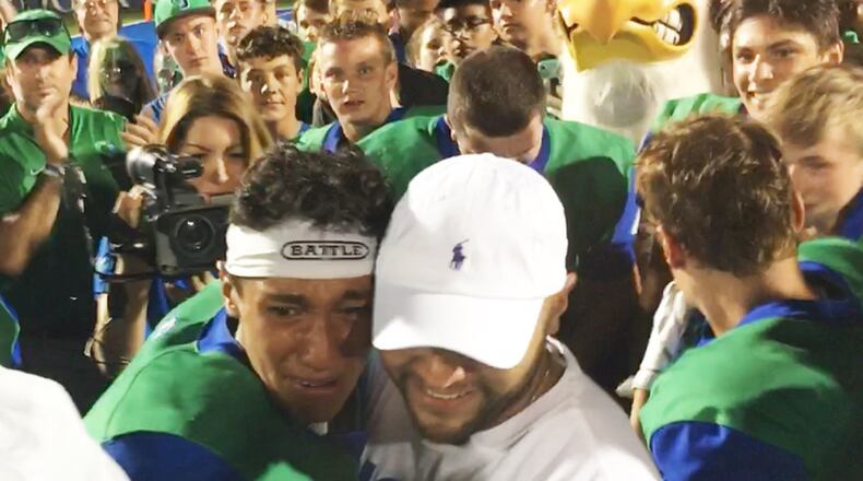 CJ quarterback Ryan Minor (left) celebrated a 58-16 Week 3 defeat of visiting Greenville last season with a surprise visit from his father, Chris Minor, a captain who’s deployed at Turkey with the U.S. Air Force. MARC PENDLETON / STAFF