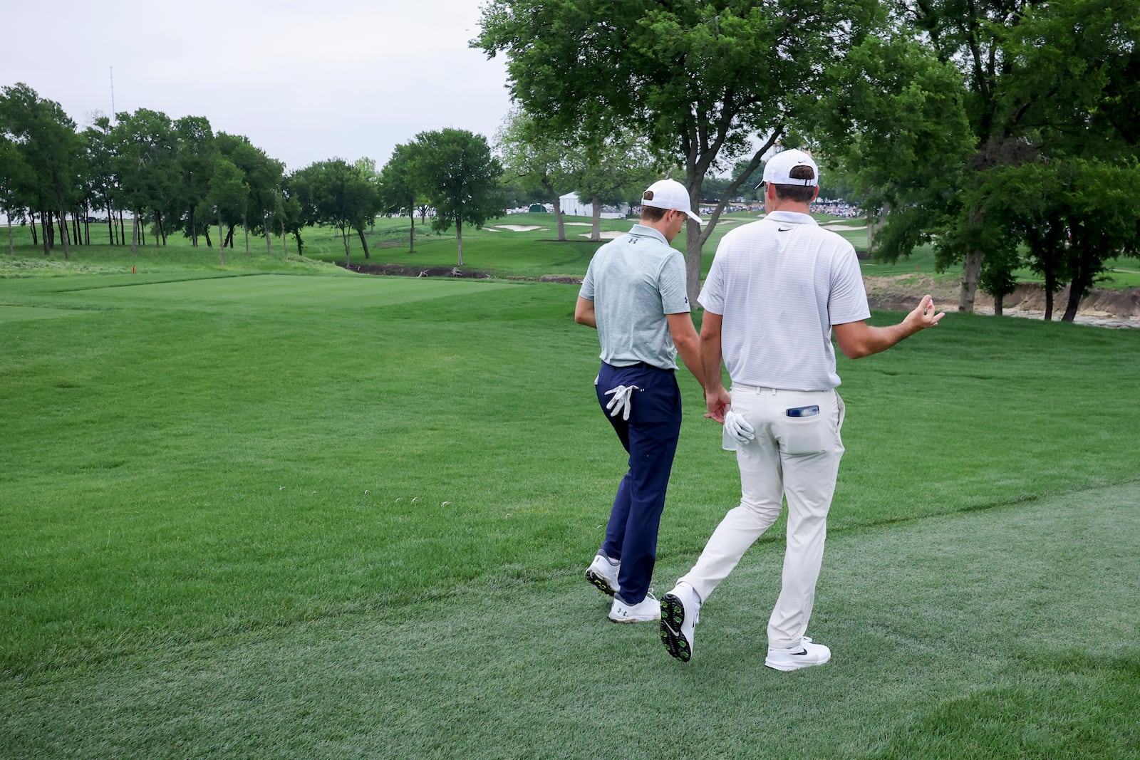 Jordan Spieth, left, and Scottie Scheffler, right, walk the sixth fairway together during the first round of the CJ Cup Byron Nelson golf tournament in McKinney, Texas, Thursday, May 1, 2025. (AP Photo/Gareth Patterson)