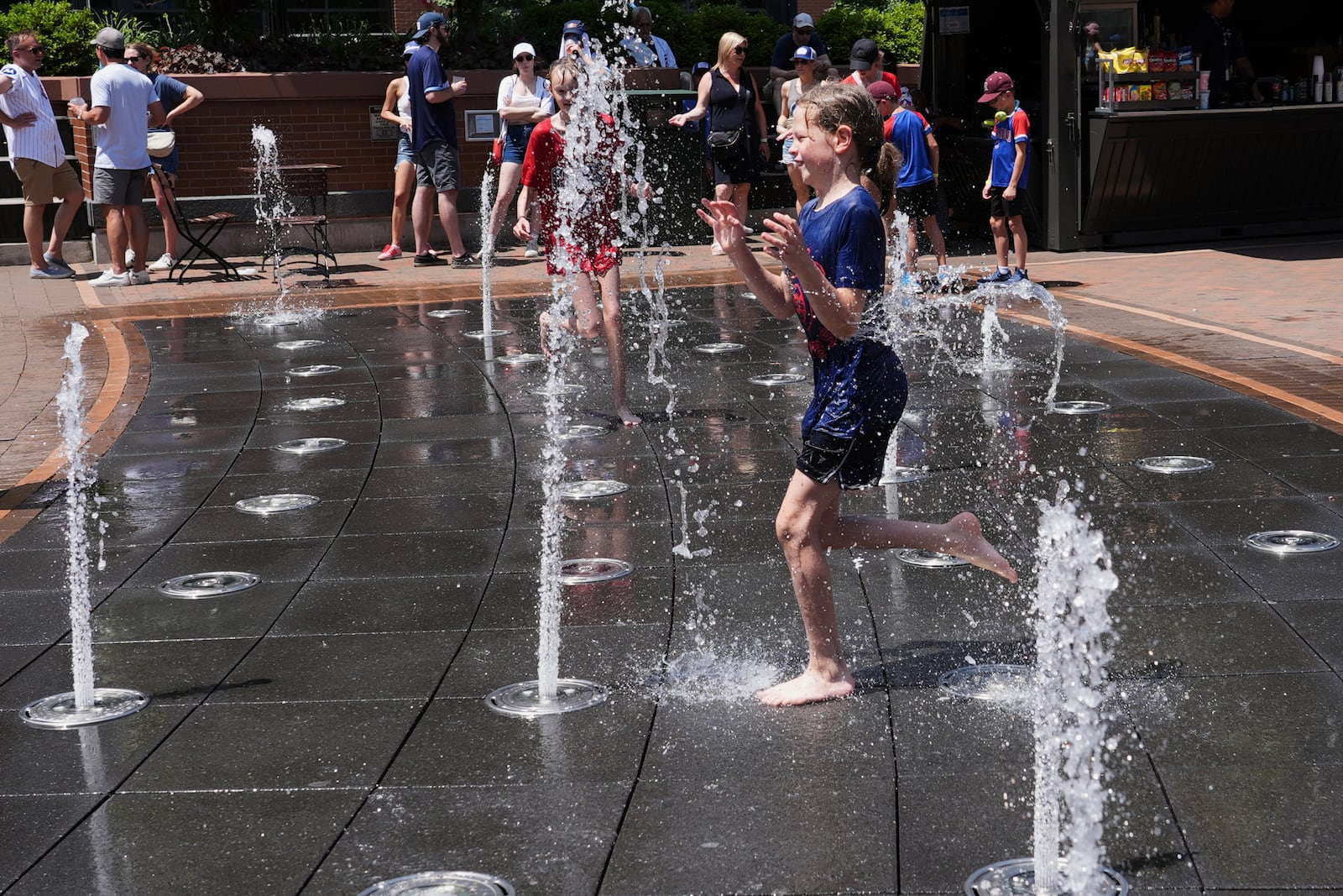 Jude Puroway cools off at a fountain during hot weather in Chicago, Sunday, June 22, 2025. (AP Photo/Nam Y. Huh)